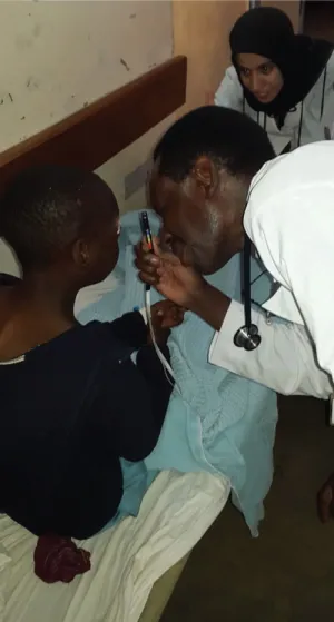 Trainee using an Arclight ophthalmoscope in the workplace.
