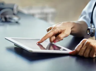 IStock 1033783576 Doctor Checking Tablet