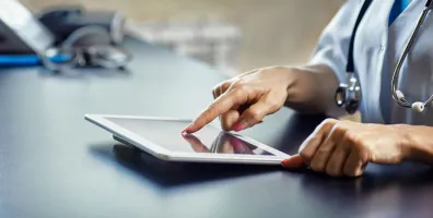IStock 1033783576 Doctor Checking Tablet